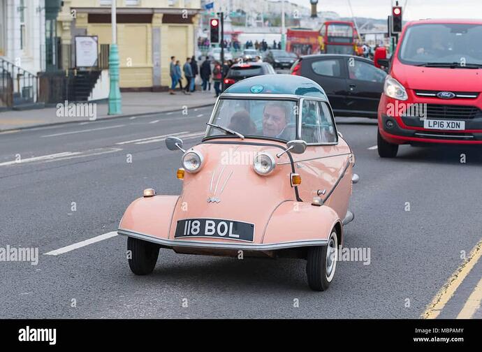 200cc-pink-3-wheeled-messerschmitt-classic-bubble-car-from-1960-being-driven-on-a-british-road-in-england-uk-MBPAMY